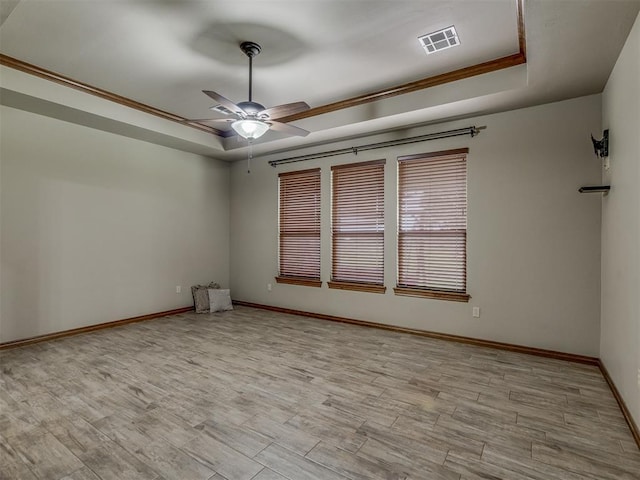 1960 Bermuda Dr, Newcastle, OK 73065 - empty room with a tray ceiling, ceiling fan, baseboards, wood finished floors, and crown molding