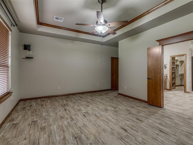1960 Bermuda Dr, Newcastle, OK 73065 - unfurnished room with a tray ceiling, ceiling fan, light wood-type flooring, baseboards, and ornamental molding