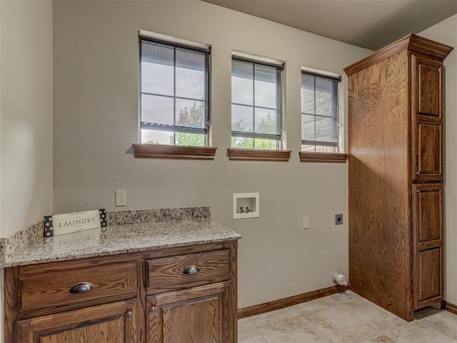 1960 Bermuda Dr, Newcastle, OK 73065 - laundry area with hookup for a washing machine, electric dryer hookup, cabinet space, baseboards, and light tile patterned flooring