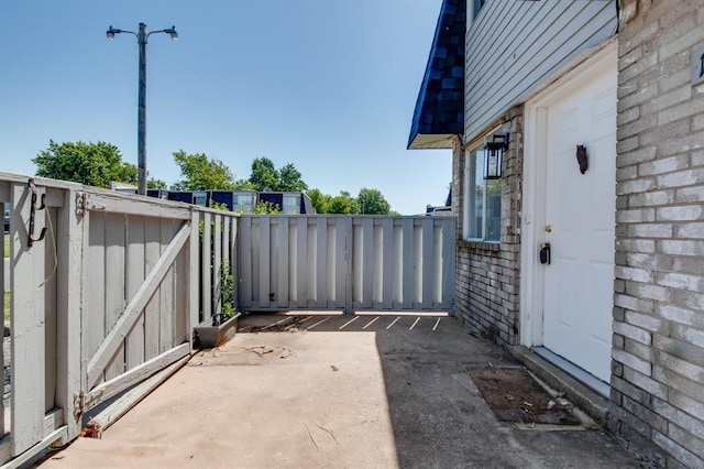 view of patio / terrace featuring fence and a gate