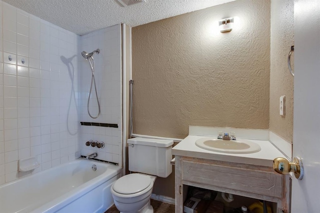 bathroom featuring a textured wall, vanity, a textured ceiling, toilet, and washtub / shower combination