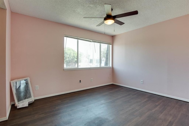 unfurnished room featuring dark wood-type flooring, a ceiling fan, a textured ceiling, and baseboards