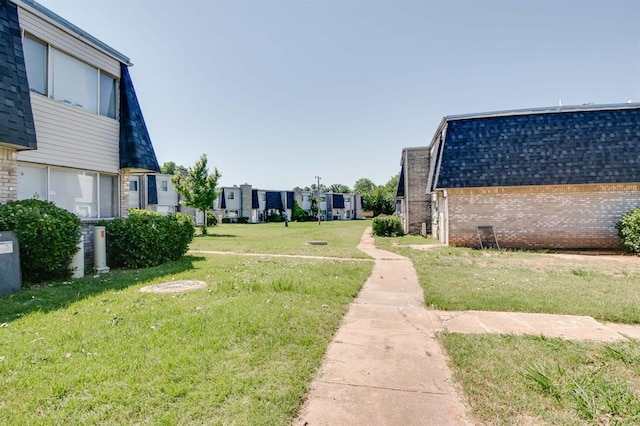 view of home's community with a yard and a residential view