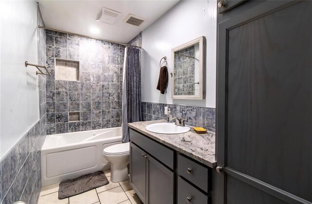 330917 E 940th Rd, Wellston, OK 74881 - full bath with tile patterned flooring, tile walls, toilet, shower / tub combo, and vanity