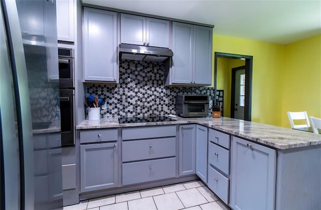 330917 E 940th Rd, Wellston, OK 74881 - kitchen featuring black electric cooktop, a peninsula, gray cabinets, tasteful backsplash, and light tile patterned flooring