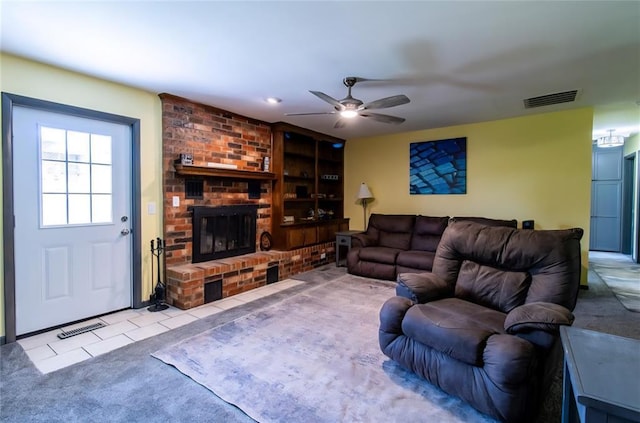 330917 E 940th Rd, Wellston, OK 74881 - carpeted living area with ceiling fan, a fireplace, and tile patterned flooring