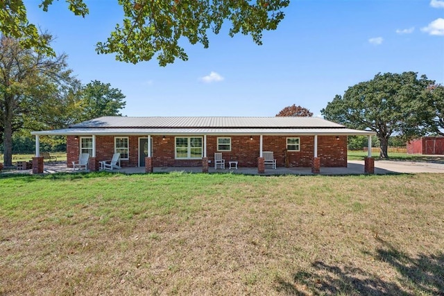 20302 Kings Rd, Shawnee, OK 74801 - ranch-style home featuring brick siding, a patio, and a front yard