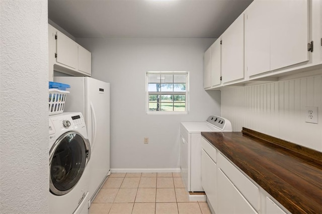 20302 Kings Rd, Shawnee, OK 74801 - washroom with separate washer and dryer, cabinet space, light tile patterned floors, and baseboards