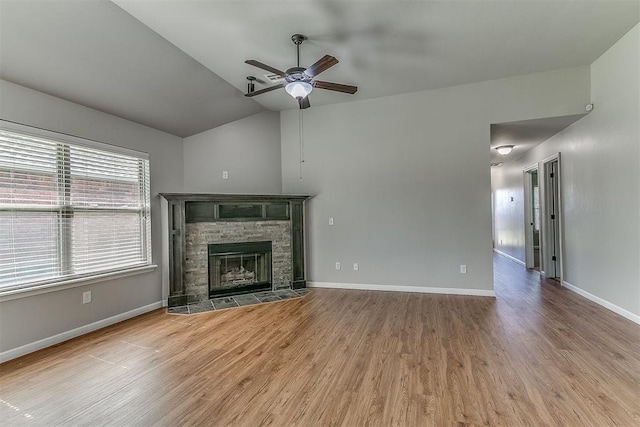 4108 NW 154th St, Edmond, OK 73013 - unfurnished living room with vaulted ceiling, a ceiling fan, wood finished floors, baseboards, and a tile fireplace