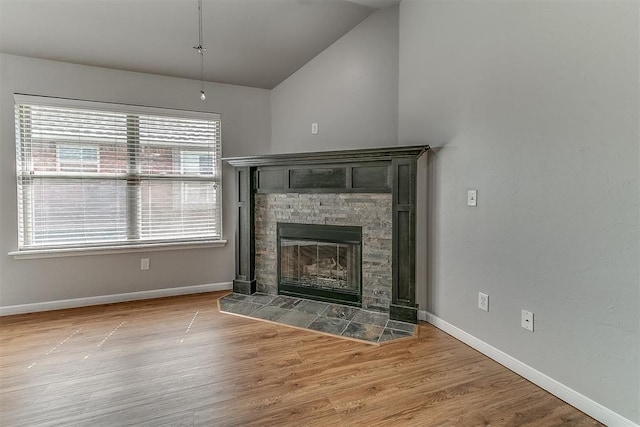 4108 NW 154th St, Edmond, OK 73013 - unfurnished living room with vaulted ceiling, baseboards, a fireplace, and wood finished floors
