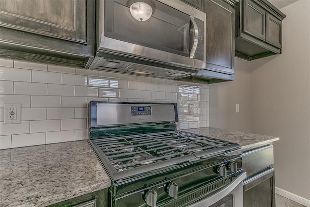 4108 NW 154th St, Edmond, OK 73013 - kitchen with appliances with stainless steel finishes, tasteful backsplash, dark brown cabinetry, and light stone counters