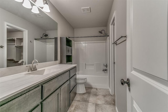 4108 NW 154th St, Edmond, OK 73013 - full bathroom with vanity, toilet, washtub / shower combination, stone finish flooring, and a spacious closet