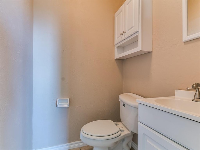 bathroom with toilet and vanity