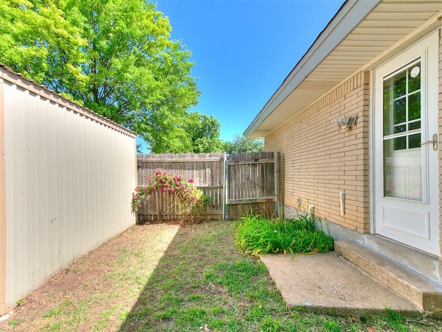 view of yard with fence and entry steps