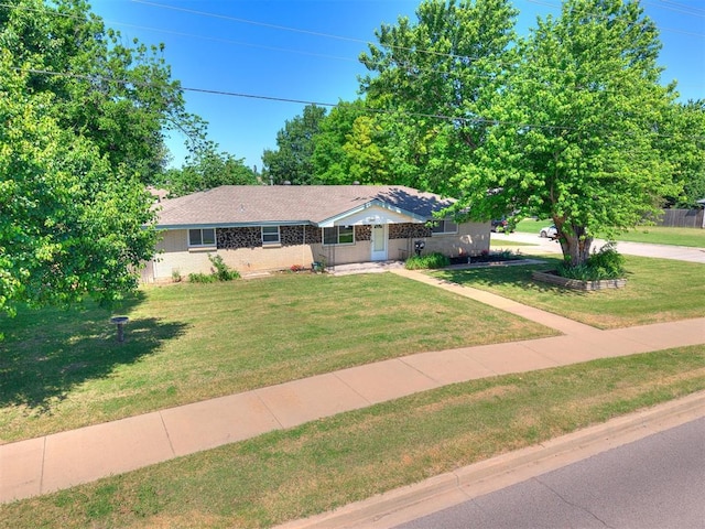 view of front of property featuring a front lawn and brick siding