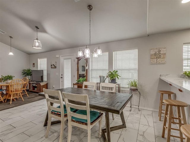 1466 County Rd 1188, Tuttle, OK 73089 - dining room with light marble finish flooring, vaulted ceiling, and a chandelier