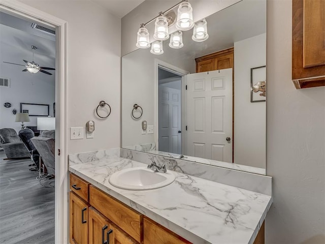 1466 County Rd 1188, Tuttle, OK 73089 - bathroom with vanity, a ceiling fan, and wood finished floors