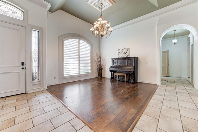 14812 Maplelake Dr, Edmond, OK 73013 - entrance foyer with a chandelier, arched walkways, plenty of natural light, and vaulted ceiling
