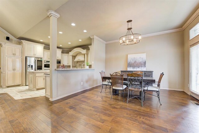14812 Maplelake Dr, Edmond, OK 73013 - dining area with plenty of natural light, light wood-style flooring, ornamental molding, a chandelier, and recessed lighting