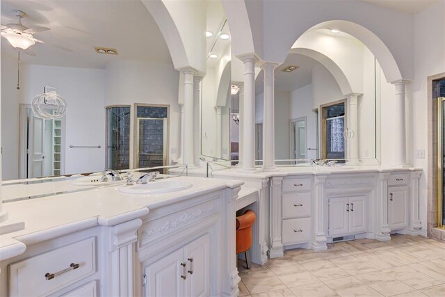 14812 Maplelake Dr, Edmond, OK 73013 - full bath featuring a ceiling fan, a shower stall, ornate columns, and vanity