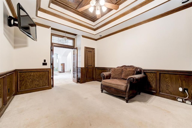 14812 Maplelake Dr, Edmond, OK 73013 - sitting room with crown molding, ceiling fan, wainscoting, arched walkways, and light colored carpet