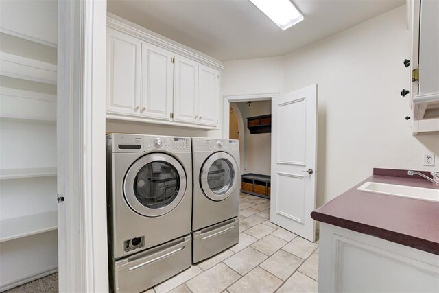 14812 Maplelake Dr, Edmond, OK 73013 - laundry area featuring washing machine and clothes dryer, cabinet space, and light tile patterned floors