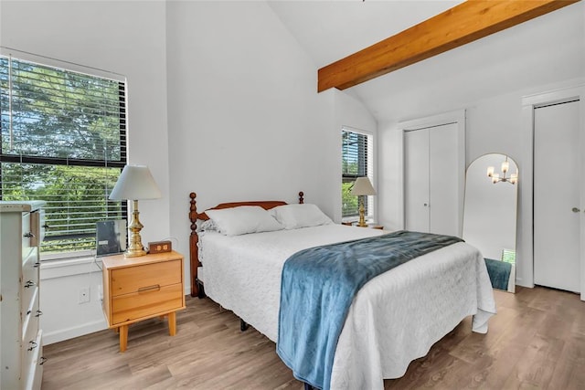 3223 Northridge Dr, Purcell, OK 73080 - bedroom featuring light wood-style floors, a chandelier, and two closets