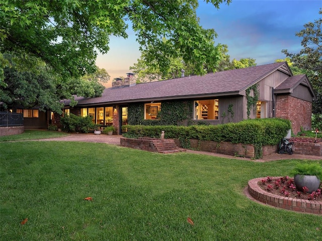 2901 NE 122nd St, Edmond, OK 73013 - ranch-style house featuring a lawn, a chimney, brick siding, and roof with shingles