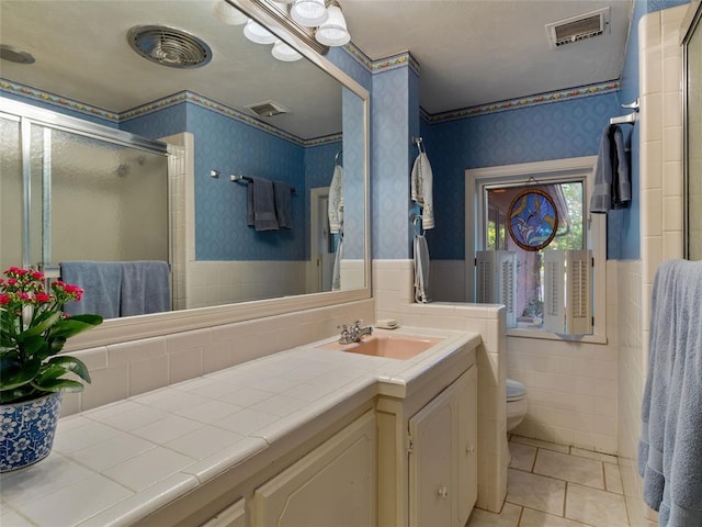 2901 NE 122nd St, Edmond, OK 73013 - full bathroom with wallpapered walls, toilet, wainscoting, tile patterned flooring, and a shower stall