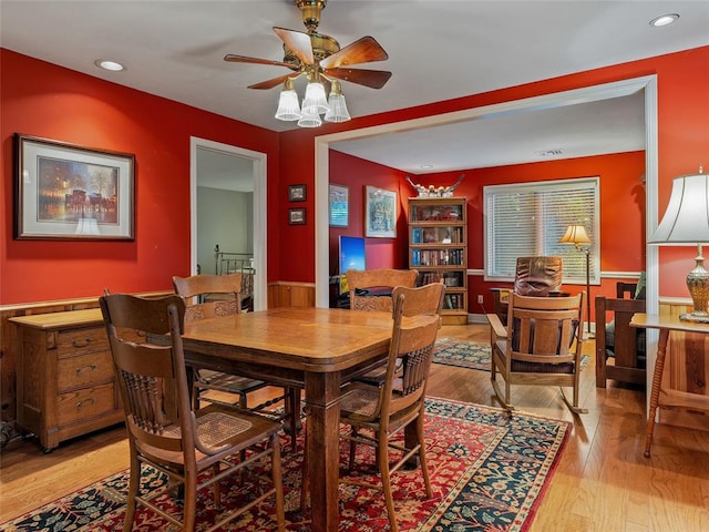 2901 NE 122nd St, Edmond, OK 73013 - dining space with ceiling fan, light wood-type flooring, wainscoting, and recessed lighting