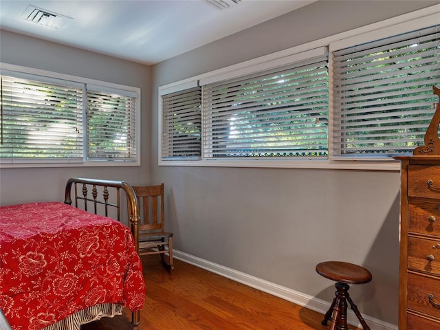 2901 NE 122nd St, Edmond, OK 73013 - bedroom featuring wood finished floors and baseboards