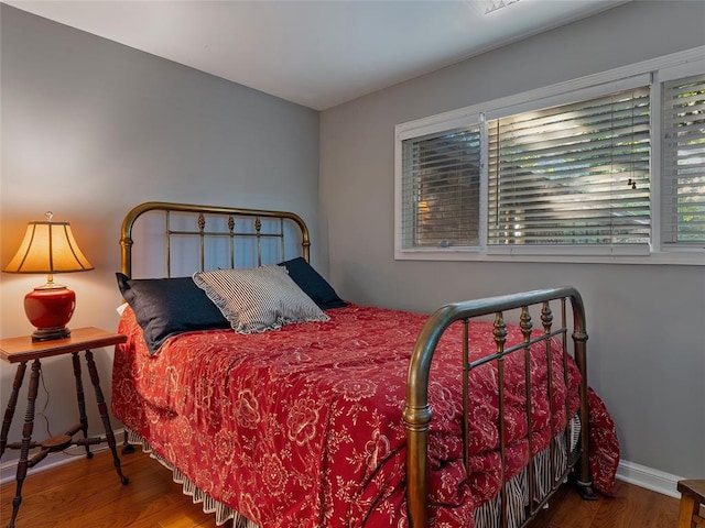 2901 NE 122nd St, Edmond, OK 73013 - bedroom with wood finished floors, multiple windows, and baseboards