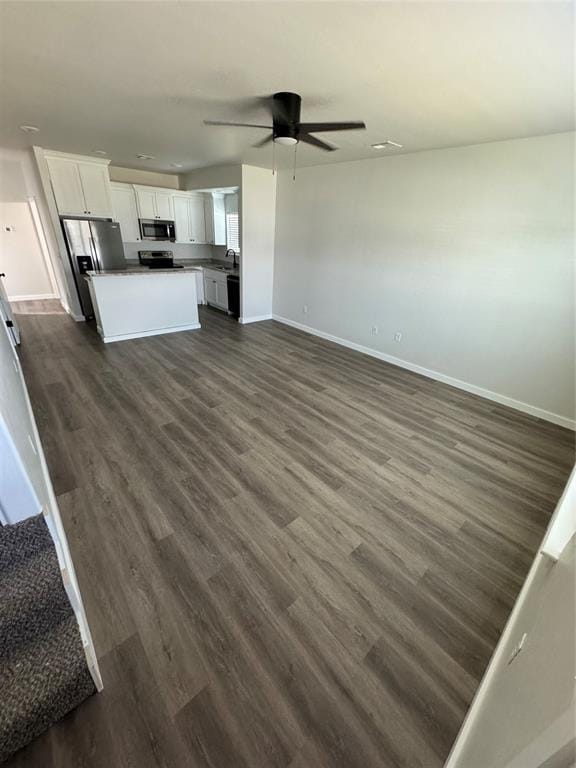 1867 Comice Dr, Newcastle, OK 73065 - kitchen with stainless steel appliances, open floor plan, baseboards, and dark wood finished floors