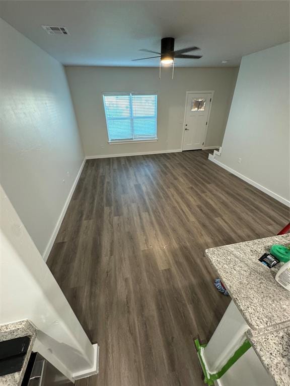 1867 Comice Dr, Newcastle, OK 73065 - unfurnished living room featuring dark wood finished floors, baseboards, and a ceiling fan