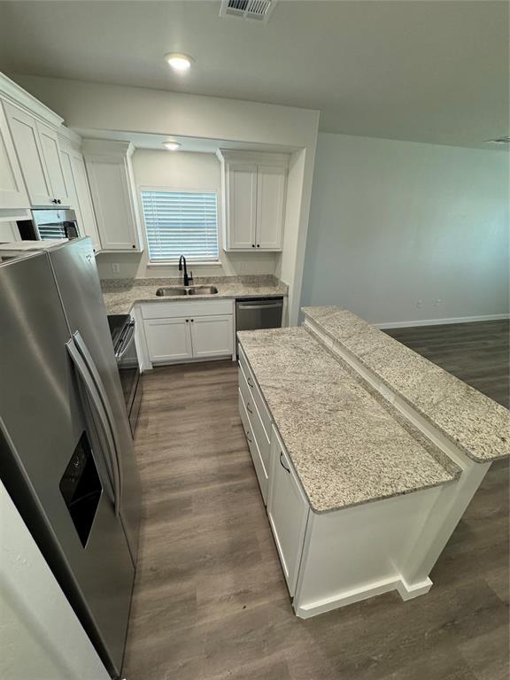 1867 Comice Dr, Newcastle, OK 73065 - kitchen with stainless steel appliances, a sink, white cabinets, and recessed lighting