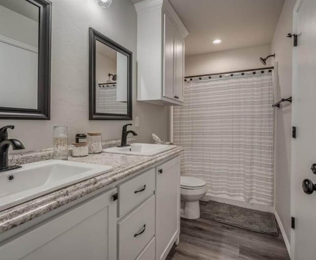 1867 Comice Dr, Newcastle, OK 73065 - full bathroom with wood finished floors, toilet, double vanity, a shower with curtain, and recessed lighting