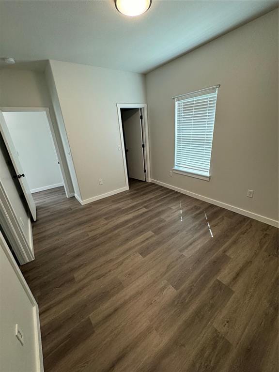 1867 Comice Dr, Newcastle, OK 73065 - unfurnished bedroom with baseboards and dark wood-type flooring
