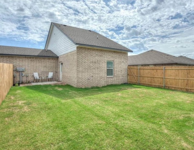 1867 Comice Dr, Newcastle, OK 73065 - rear view of house featuring brick siding and a patio area