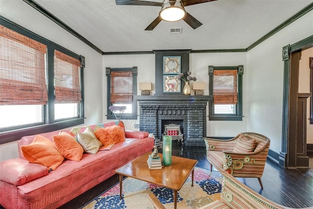 1217 NW 44th St, Oklahoma City, OK 73118 - living area with wood finished floors, crown molding, a ceiling fan, a brick fireplace, and baseboards
