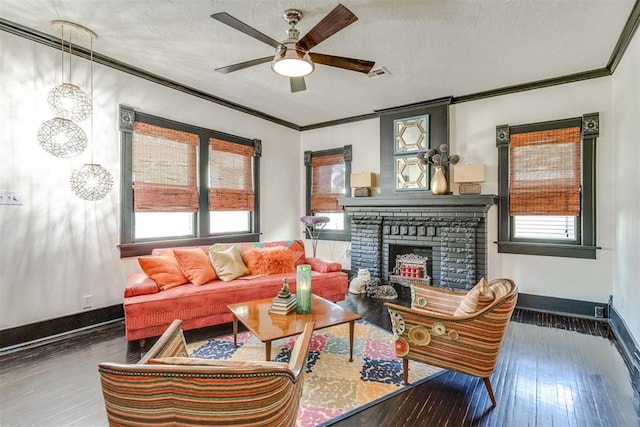 1217 NW 44th St, Oklahoma City, OK 73118 - living room with crown molding, a ceiling fan, wood finished floors, a brick fireplace, and baseboards
