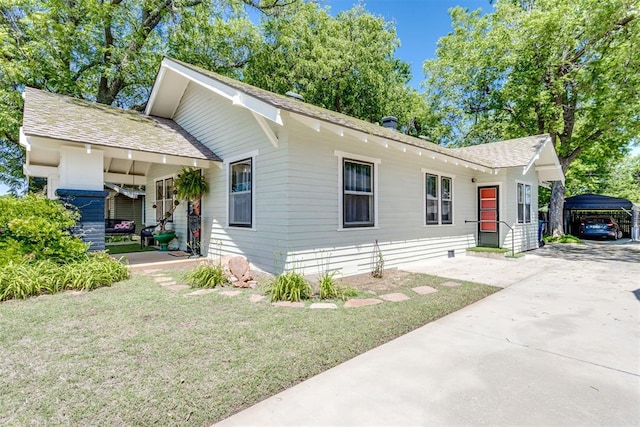 1217 NW 44th St, Oklahoma City, OK 73118 - view of front of home featuring a front lawn, a shingled roof, a porch, and driveway