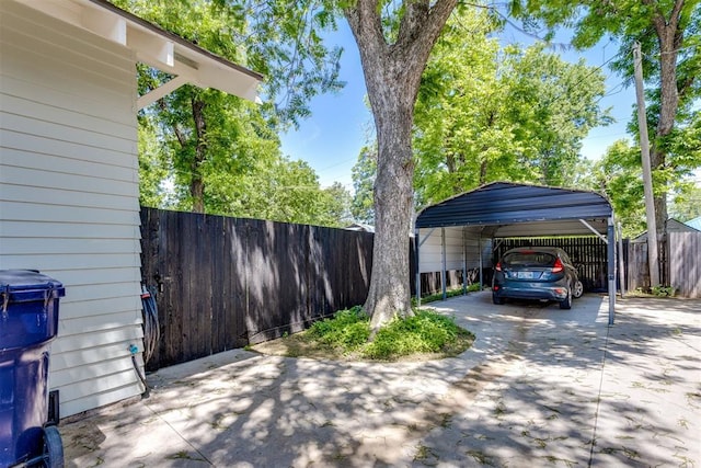 1217 NW 44th St, Oklahoma City, OK 73118 - view of vehicle parking featuring a carport and concrete driveway