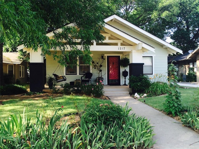 1217 NW 44th St, Oklahoma City, OK 73118 - bungalow-style house featuring a porch and a front lawn
