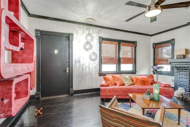 1217 NW 44th St, Oklahoma City, OK 73118 - living room with crown molding, ceiling fan, wood finished floors, baseboards, and a stone fireplace