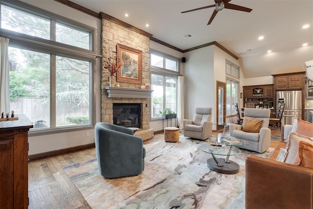 7616 NW 134th St, Oklahoma City, OK 73142 - living room with crown molding, ceiling fan, a fireplace, light wood-style floors, and baseboards