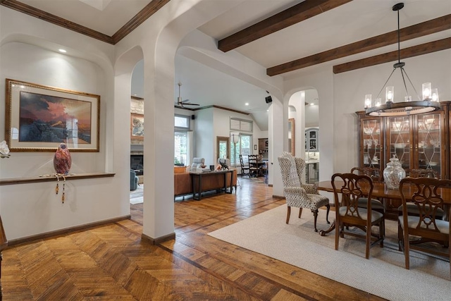 7616 NW 134th St, Oklahoma City, OK 73142 - dining space featuring arched walkways, a ceiling fan, a fireplace, a chandelier, and baseboards
