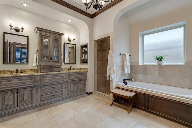 7616 NW 134th St, Oklahoma City, OK 73142 - full bath with a chandelier, a stall shower, a garden tub, crown molding, and double vanity