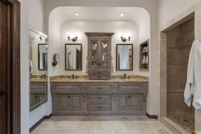 7616 NW 134th St, Oklahoma City, OK 73142 - bathroom featuring walk in shower, double vanity, and recessed lighting