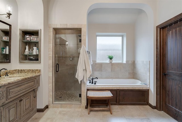7616 NW 134th St, Oklahoma City, OK 73142 - bathroom featuring a stall shower, a garden tub, vanity, and tile patterned flooring