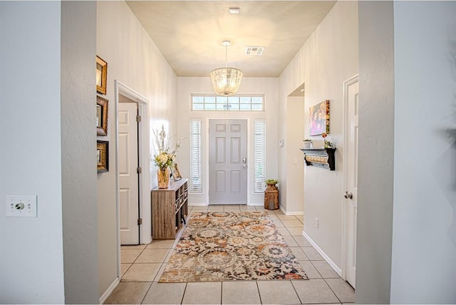 708 Ashwood Ln, Moore, OK 73160 - foyer with a chandelier, light tile patterned floors, and baseboards